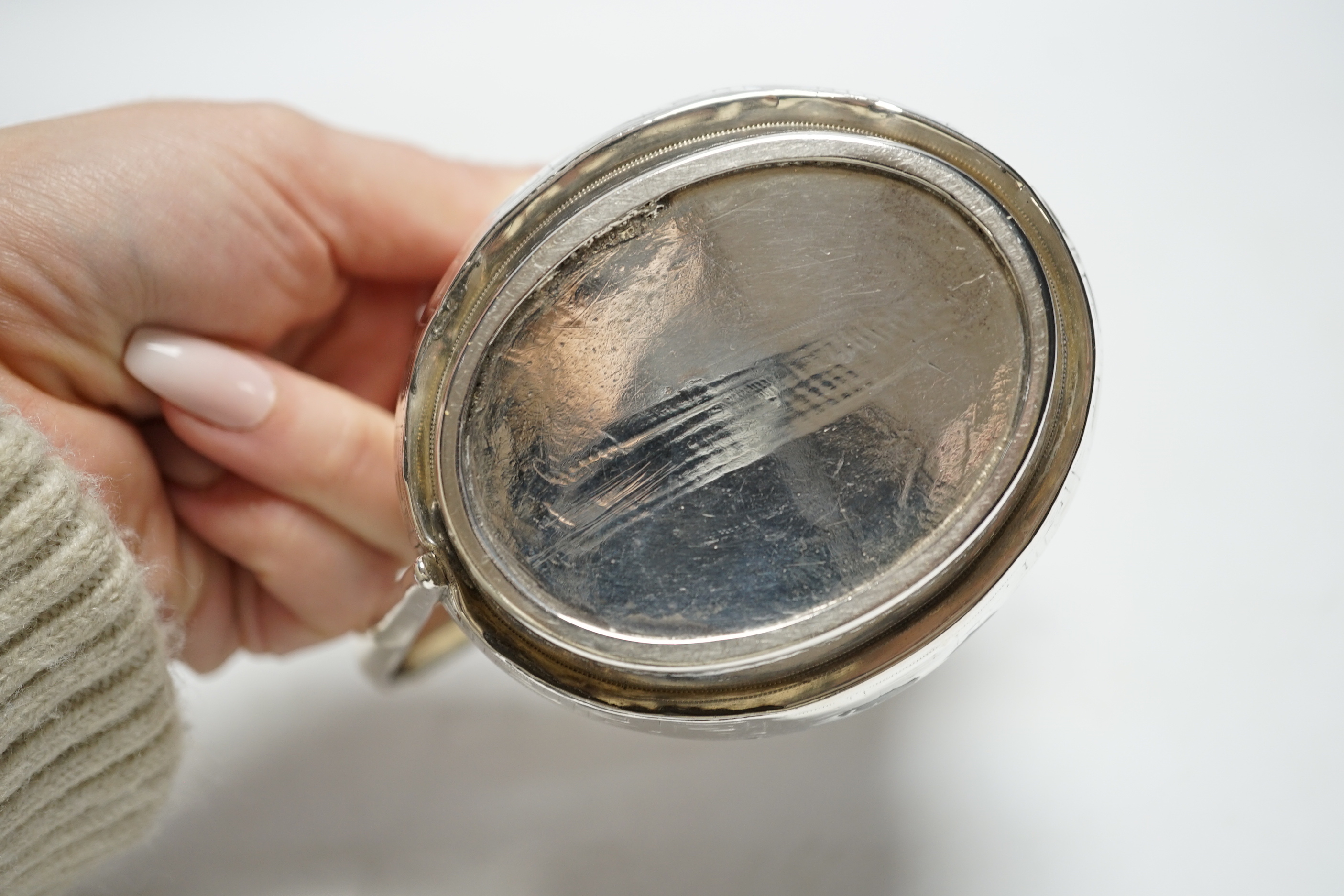 A George III silver helmet shaped cream jug, with engraved key pattern band, London 1804, 9cm. (a.f.)